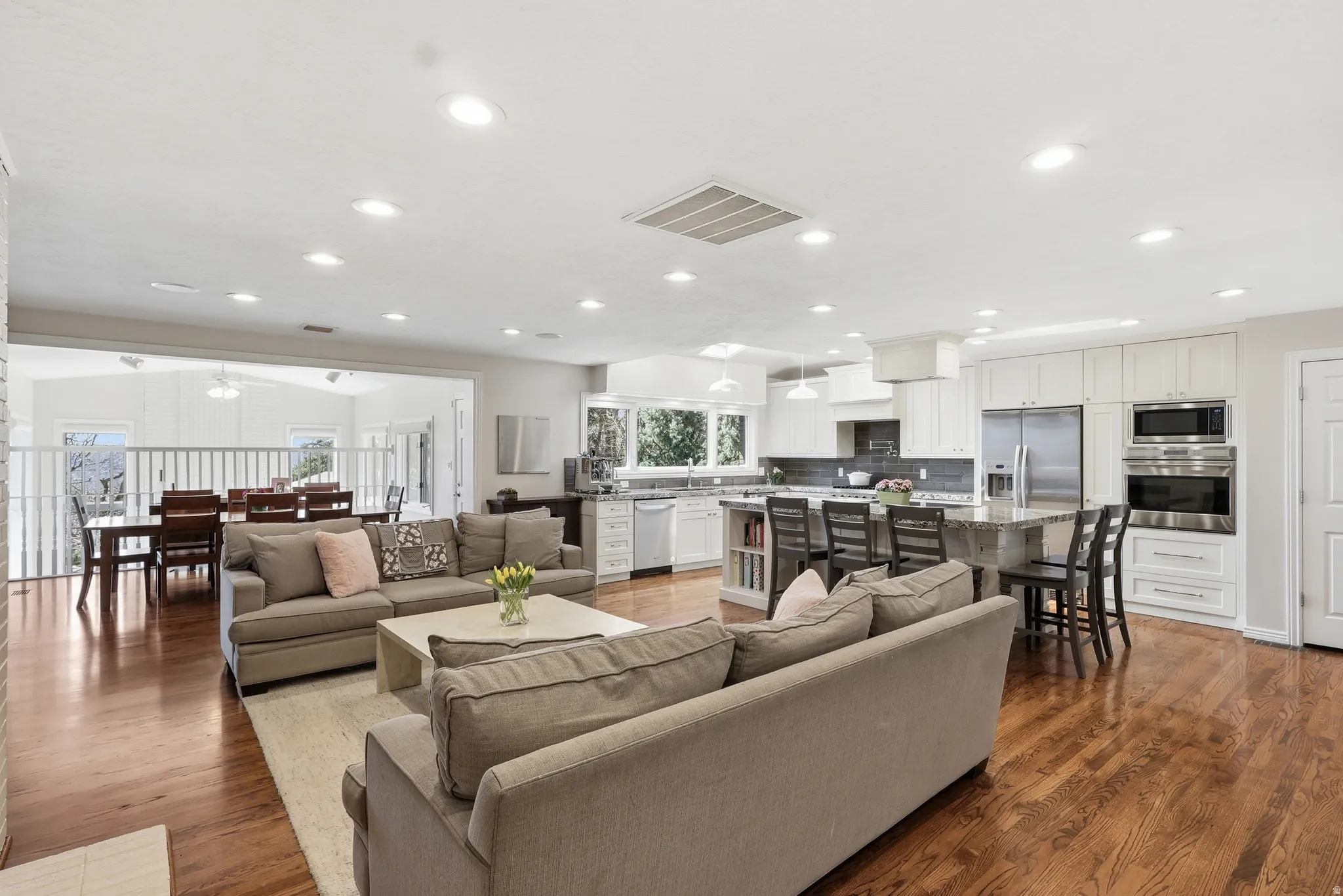 Living room with dark wood-style flooring, recessed lighting, and a ceiling fan