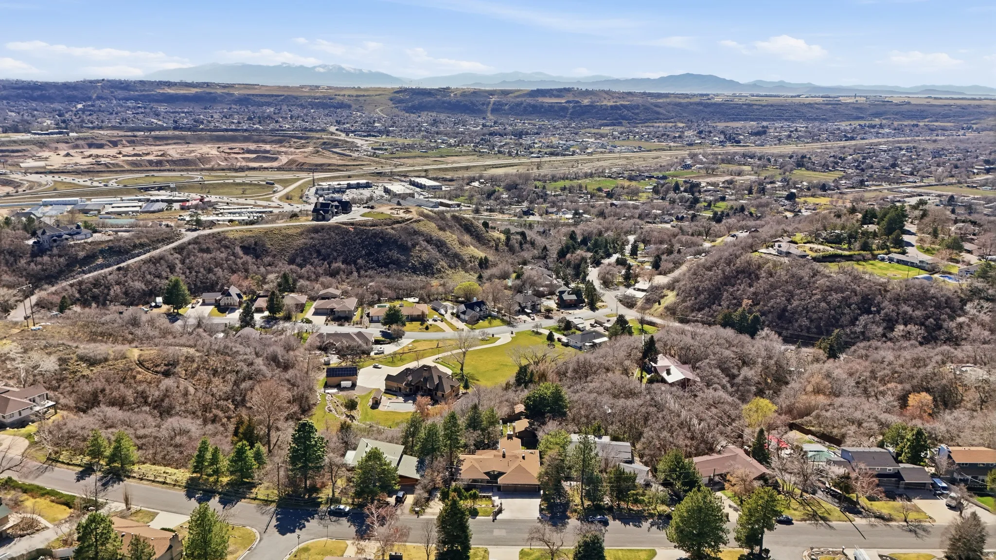 Aerial overview of property's location with nearby suburban area and a mountain backdrop