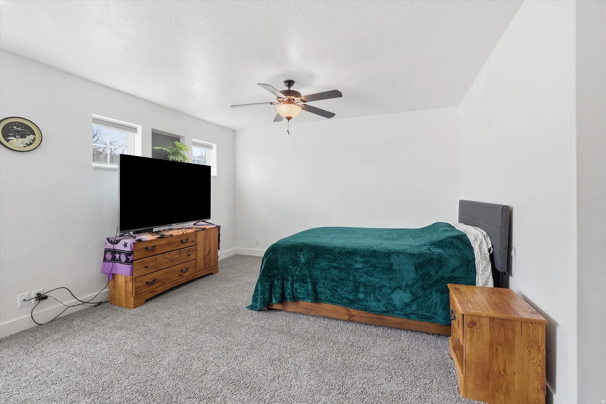 Bedroom featuring carpet and a ceiling fan