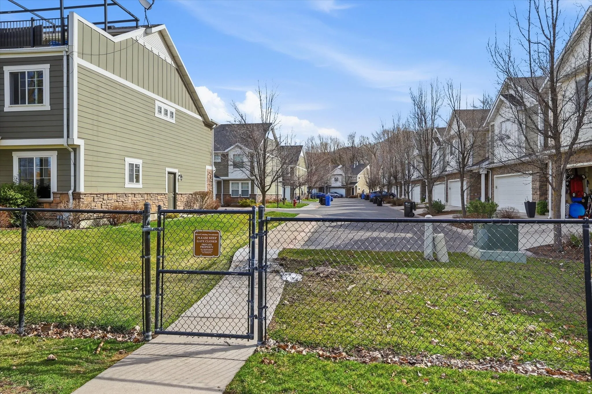 View of yard featuring a residential view and a gate