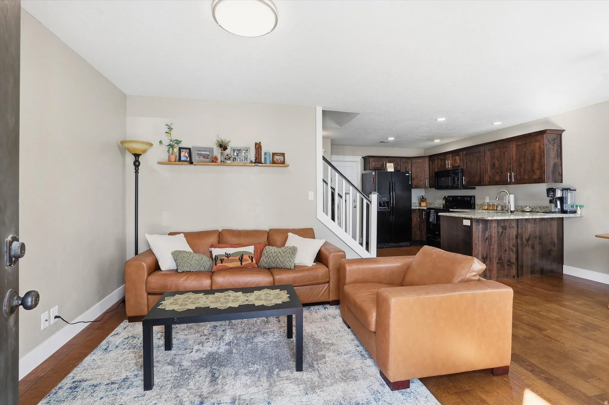 Living room featuring dark wood finished floors and recessed lighting