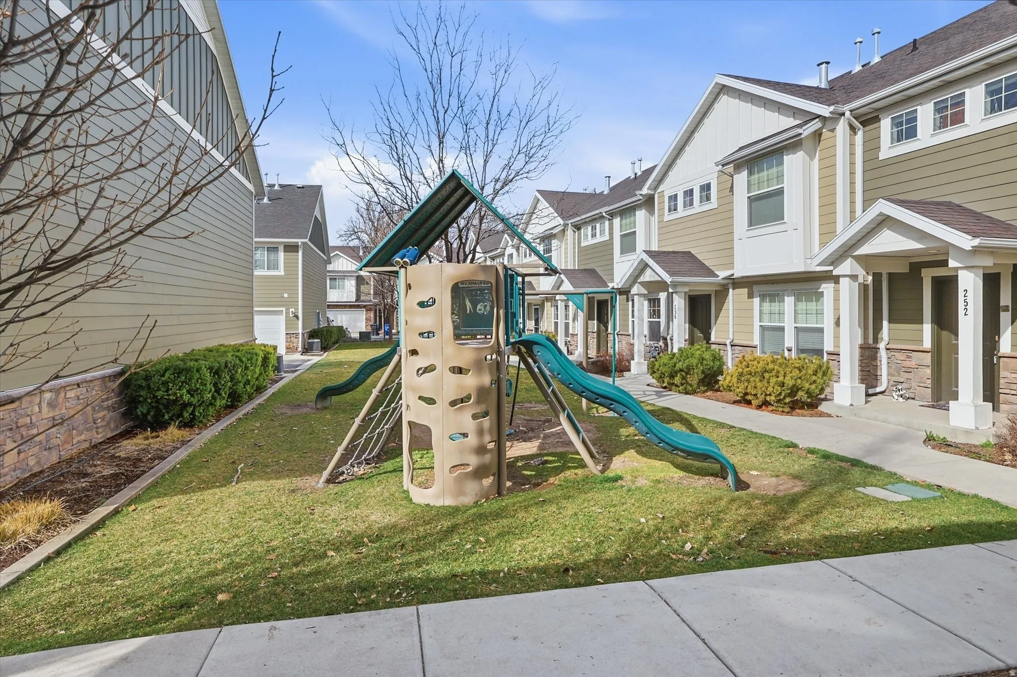 Community jungle gym featuring a residential view and a yard