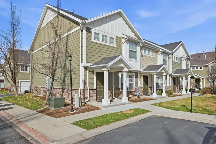 Craftsman-style house featuring board and batten siding, a porch, a residential view, stone siding, and a shingled roof