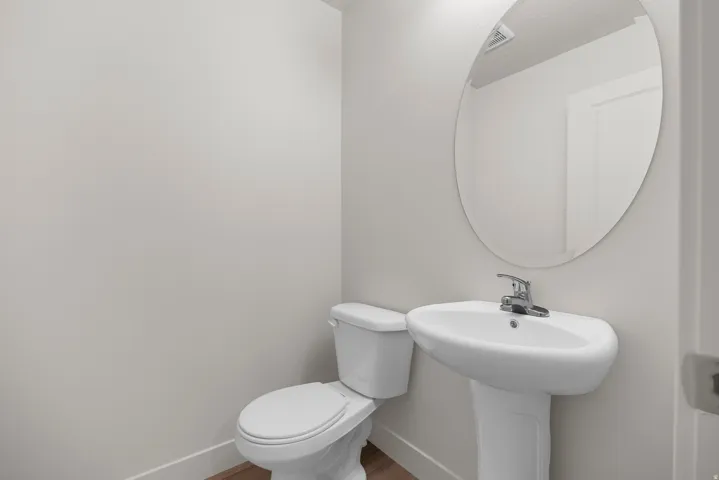 Bathroom featuring toilet and wood finished floors