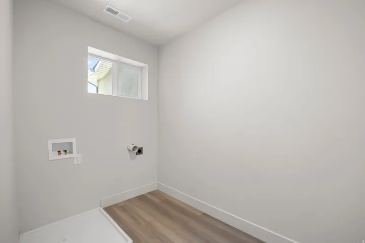 Laundry room featuring hookup for a washing machine and light wood-style flooring