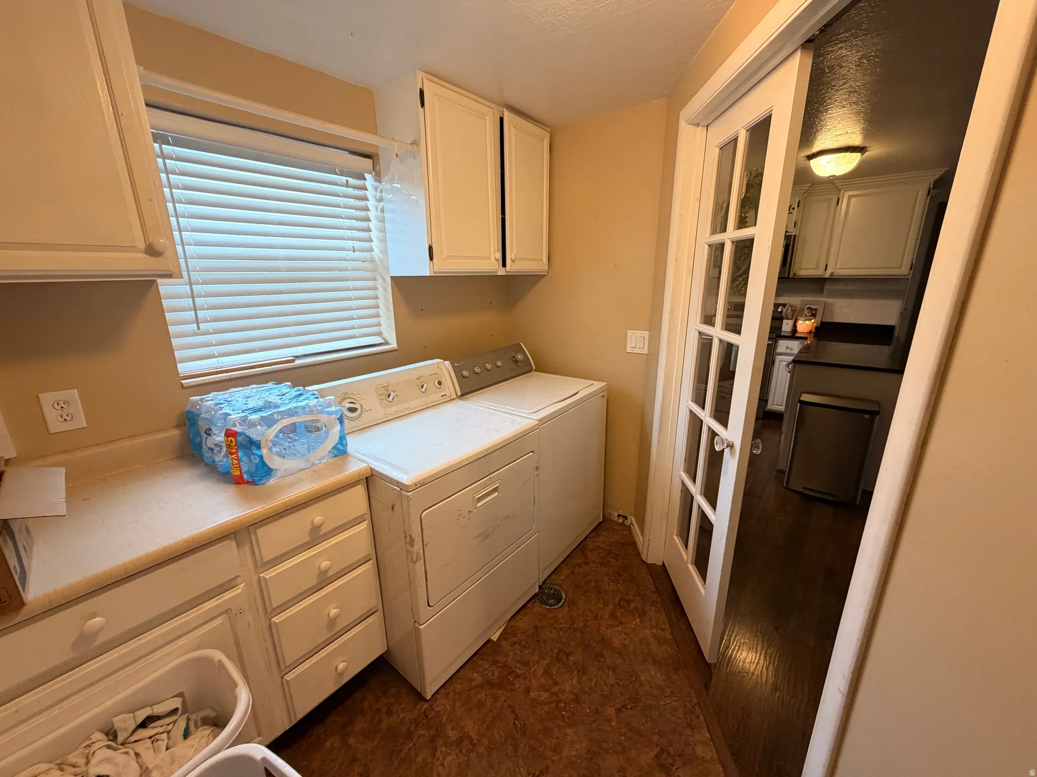 Laundry room with independent washer and dryer and cabinet space