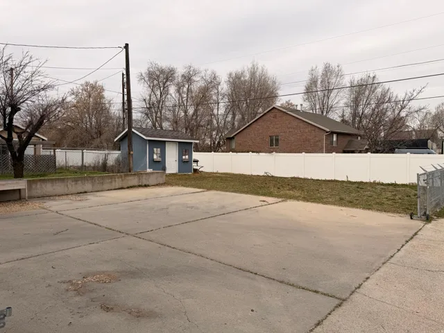Fenced backyard with a storage shed