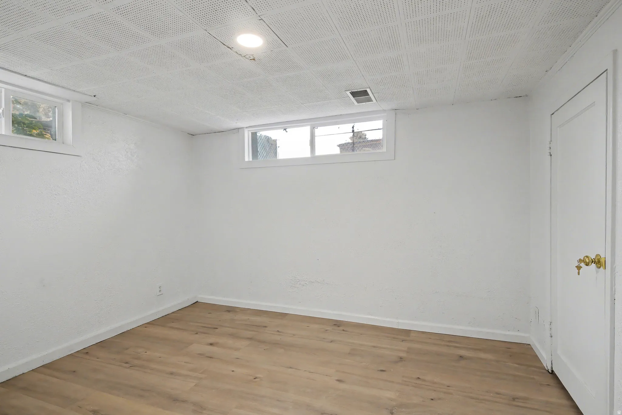 Below grade area featuring wood finished floors and baseboards