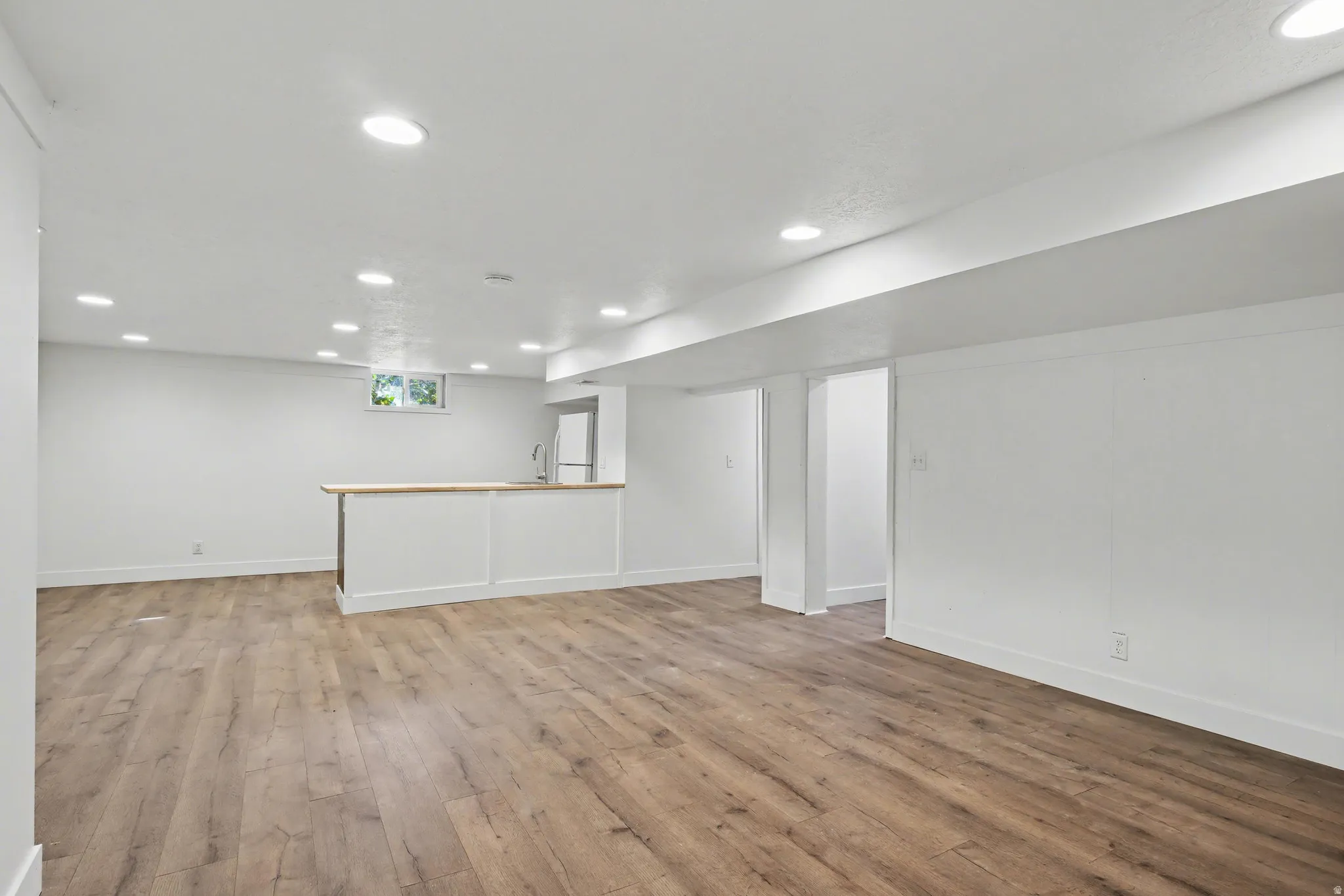 Unfurnished living room with recessed lighting and light wood-type flooring