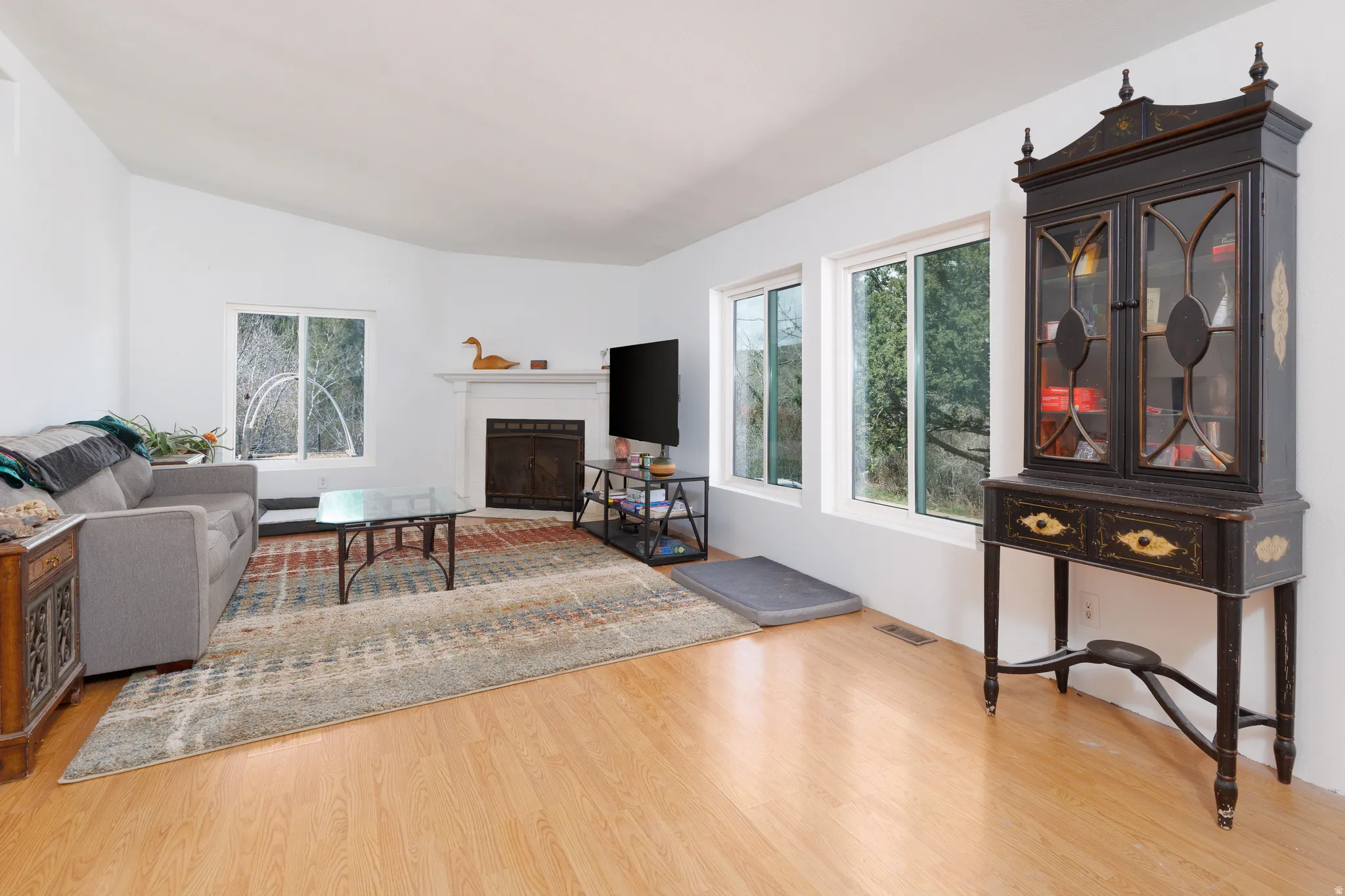 Living area featuring  light wood-style floors and a fireplace with flush hearth