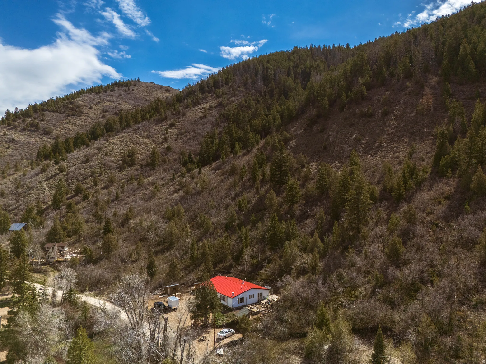 Aerial view of property with red metal roof