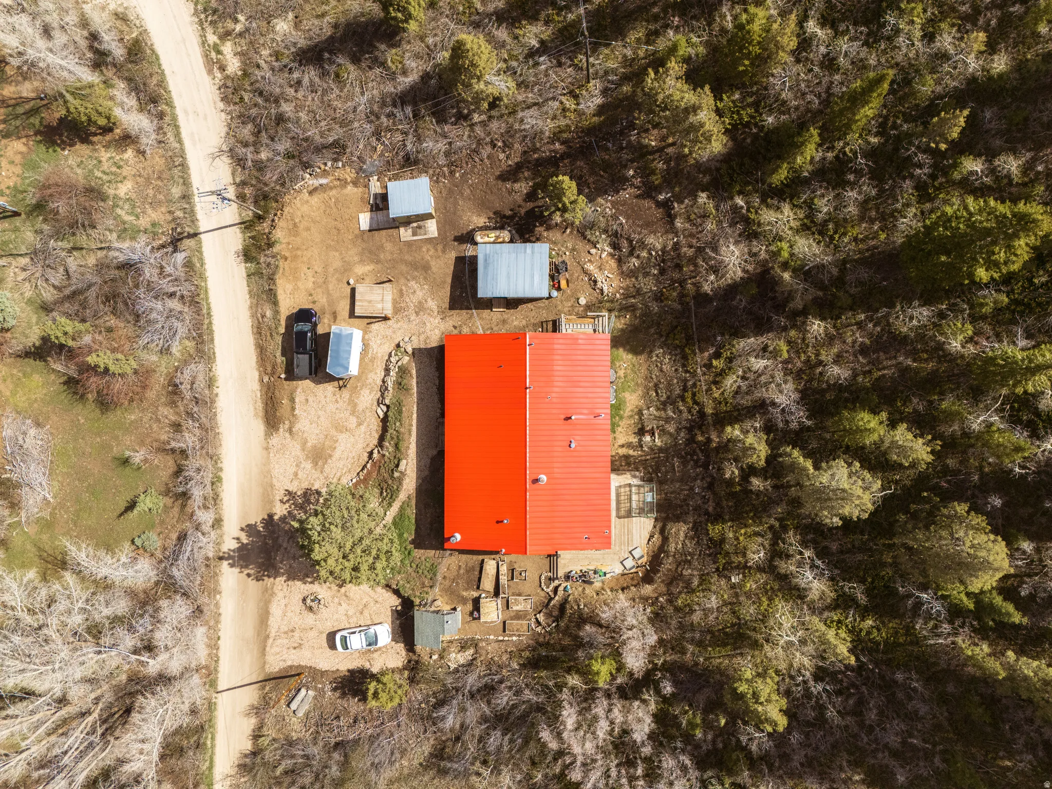 View of subject property with red metal roof