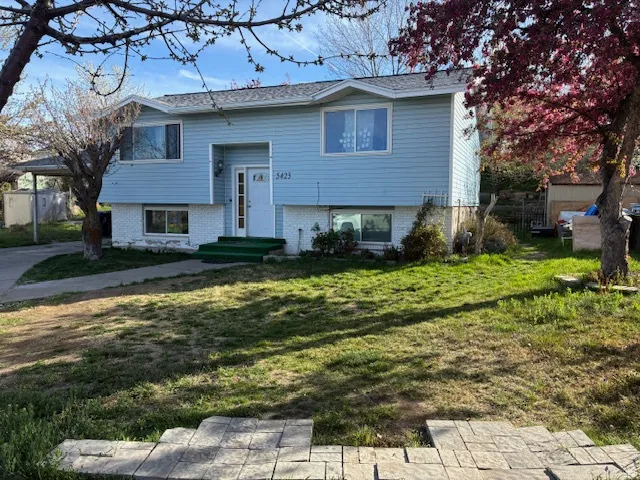 Raised ranch featuring brick siding