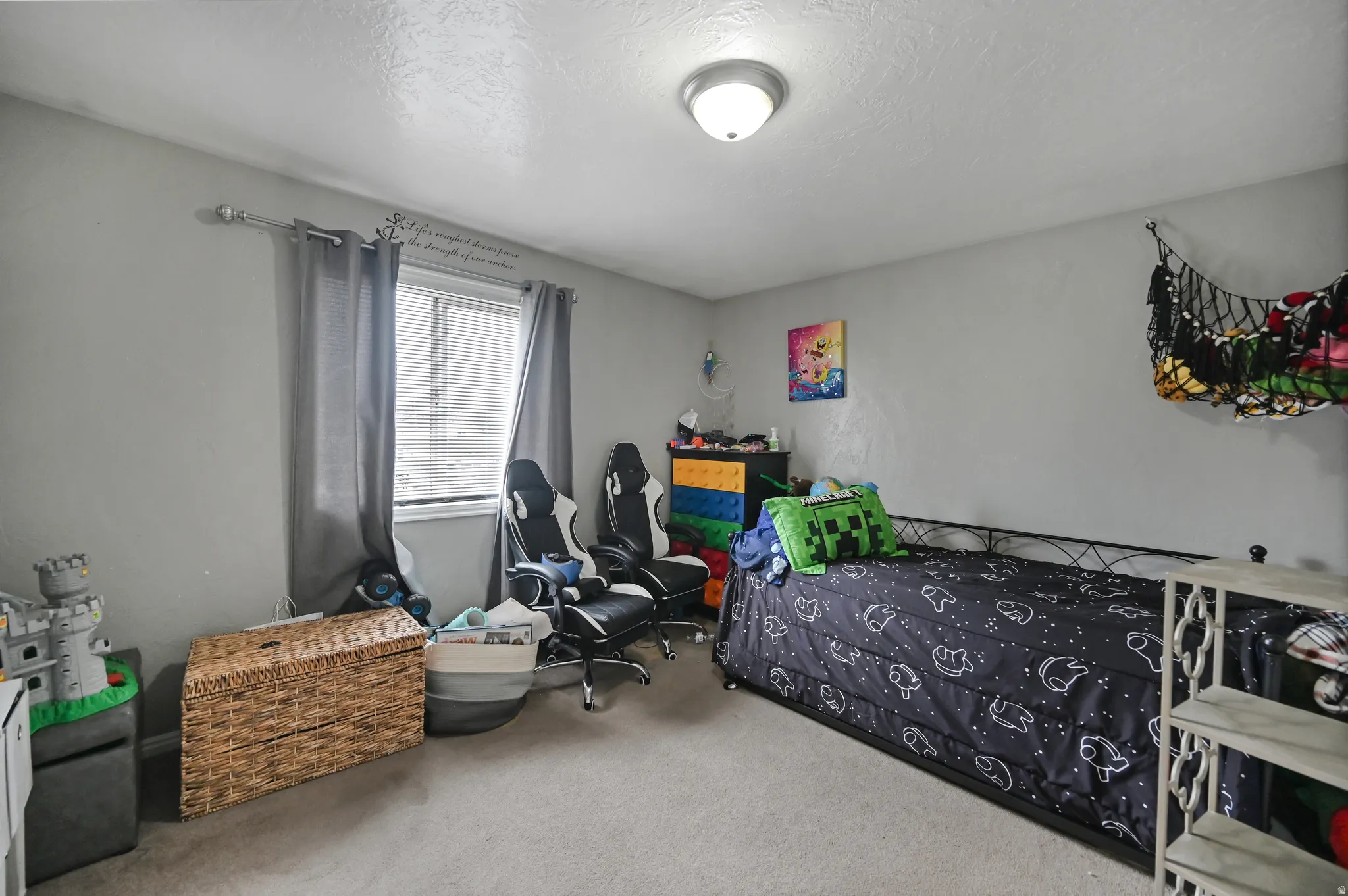 Bedroom with carpet floors and a textured ceiling