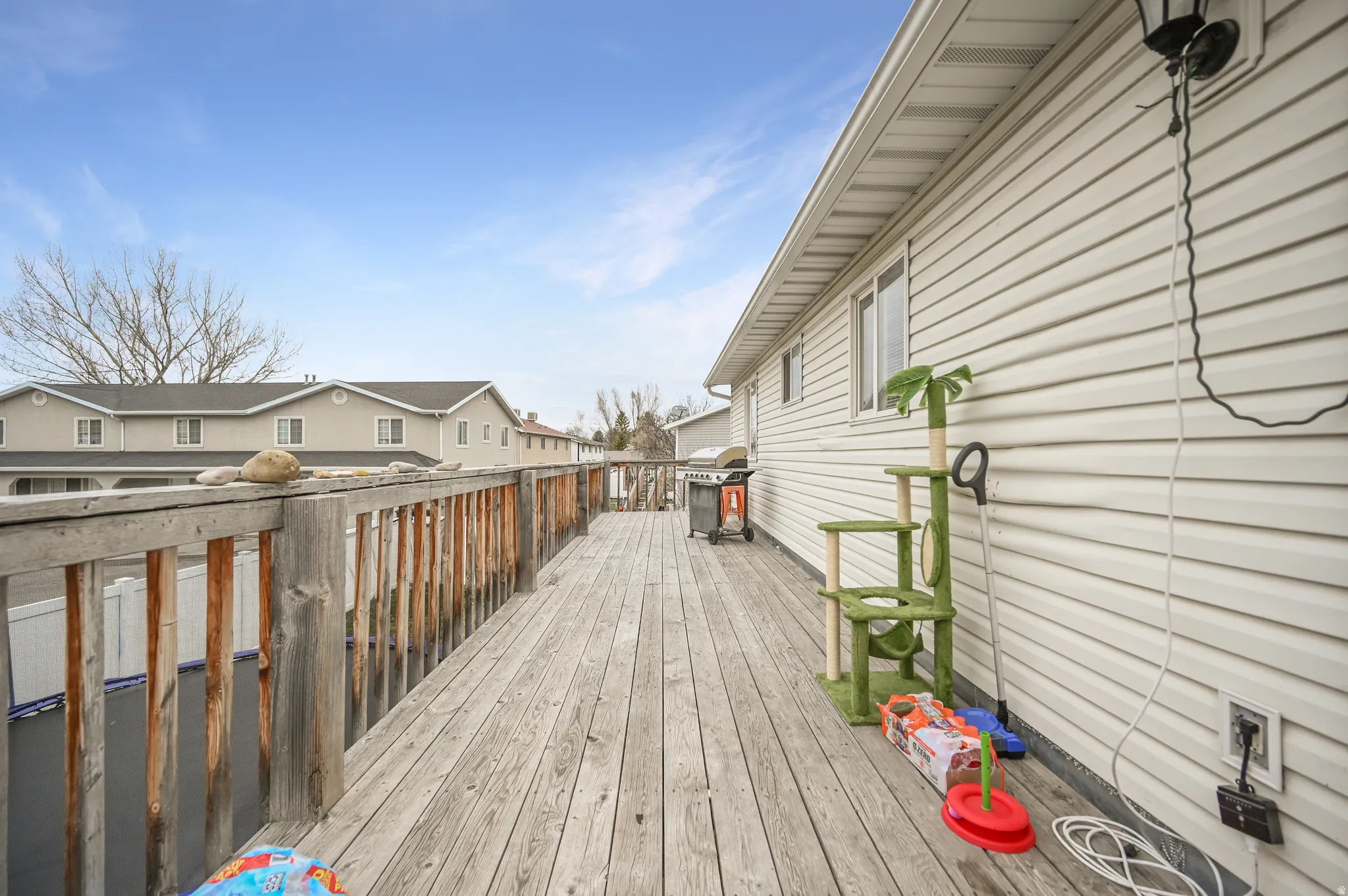 Wooden deck featuring grilling area and a residential view