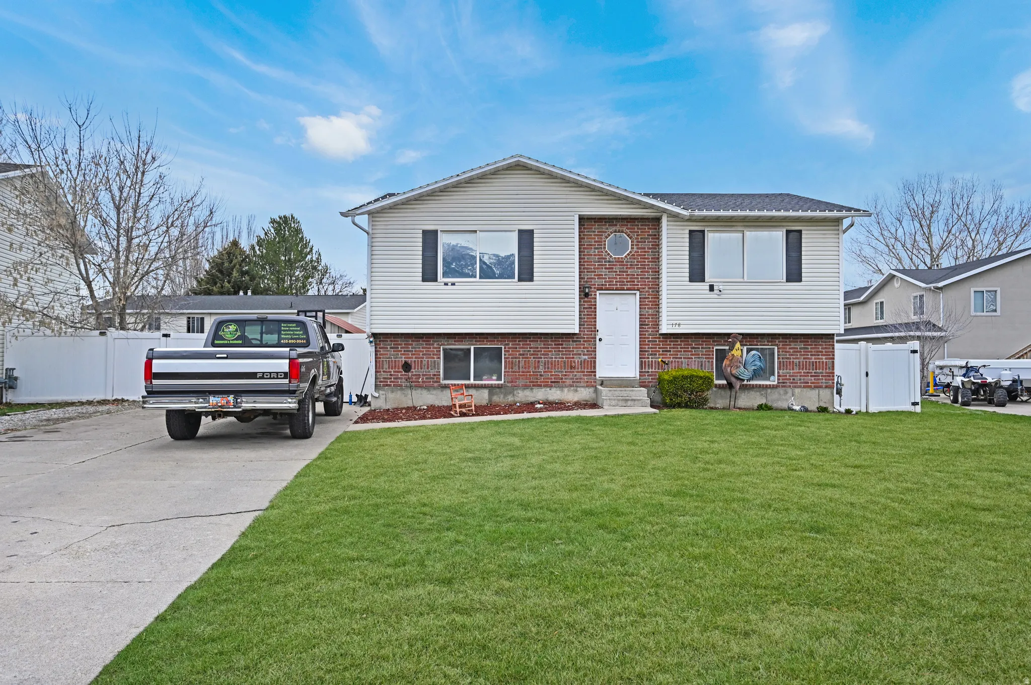 Split foyer home featuring brick siding and driveway