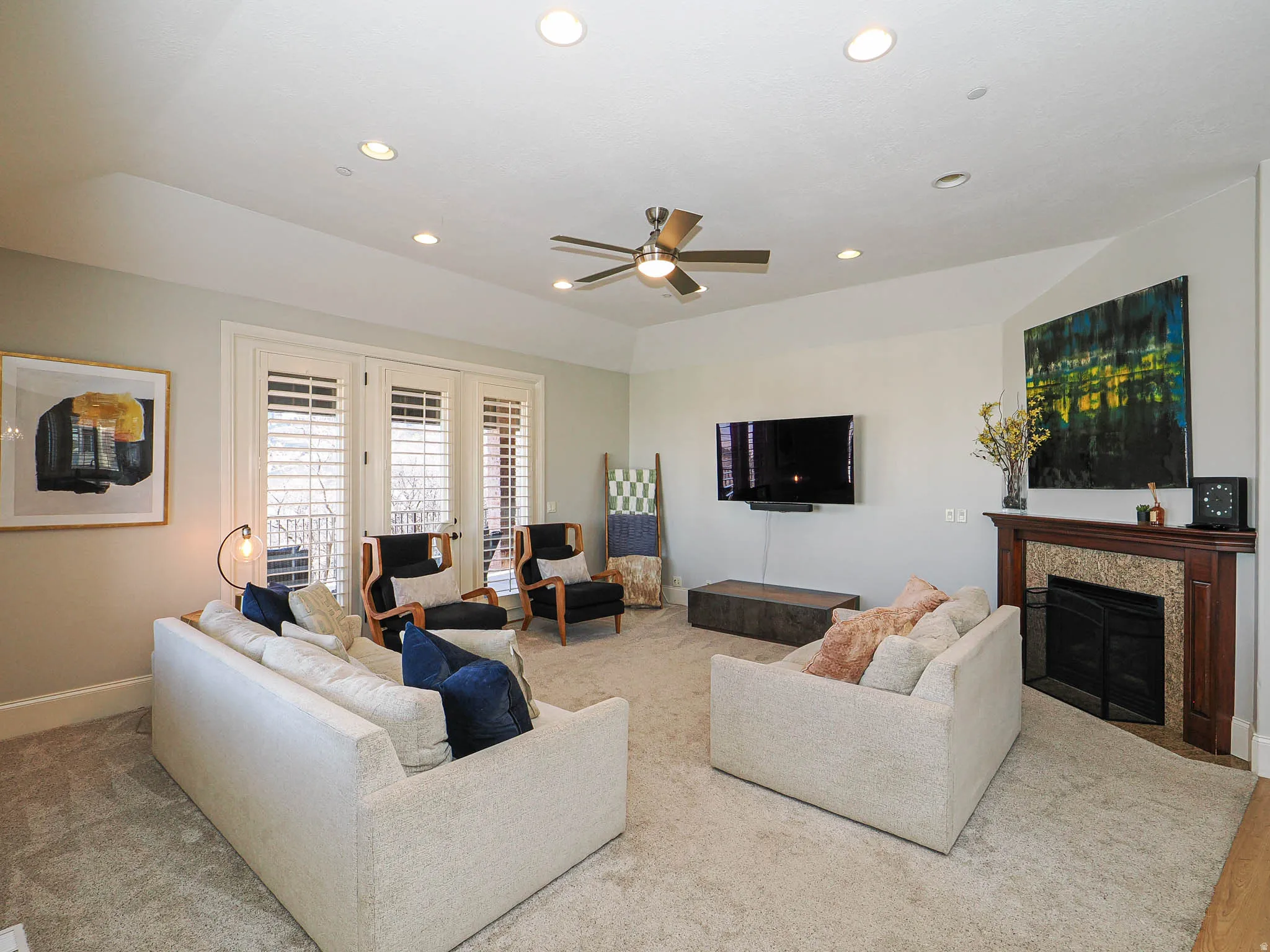 Living room featuring a ceiling fan, french doors, recessed lighting, a tiled fireplace, and carpet floors