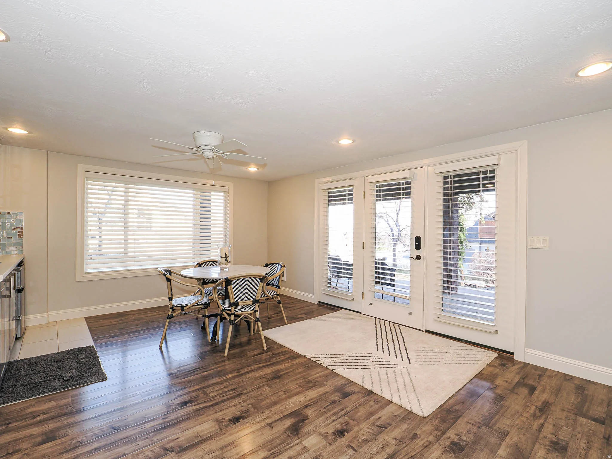 Dining area featuring dark wood-style flooring, a ceiling fan, plenty of natural light, and recessed lighting