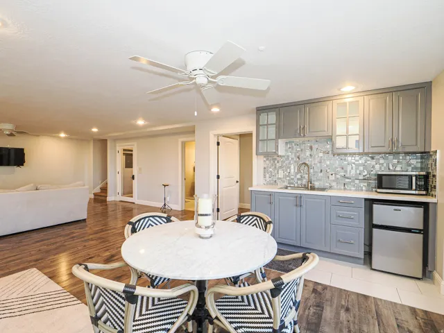 Dining area featuring ceiling fan, recessed lighting, light wood-type flooring, and wet bar