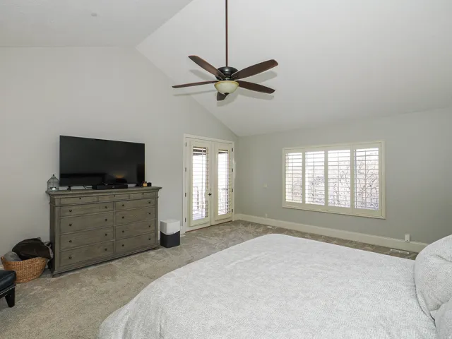 Bedroom featuring a ceiling fan, access to exterior, lofted ceiling, carpet, and french doors