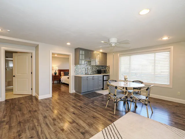 Dining area featuring dark wood-type flooring and ceiling fan