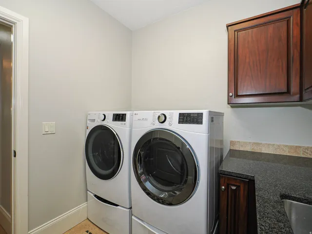 Laundry area with baseboards and washing machine and clothes dryer