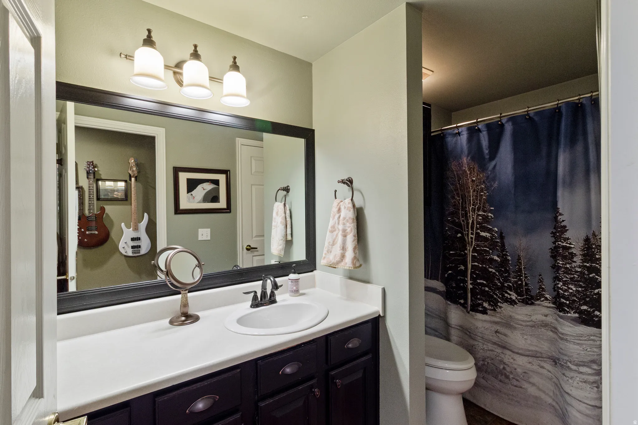 Bathroom with vanity and curtained shower