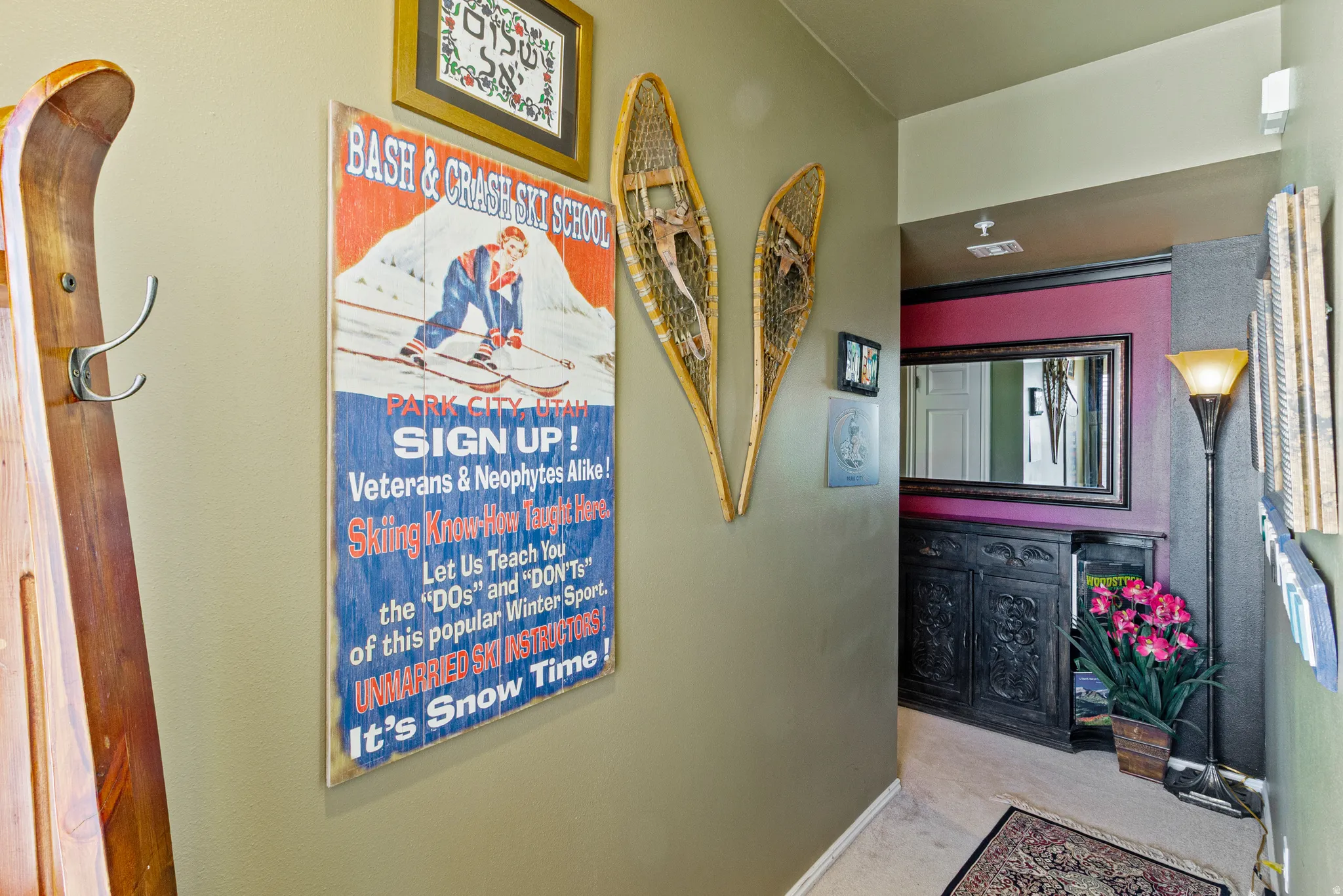 Hallway featuring light carpet and baseboards