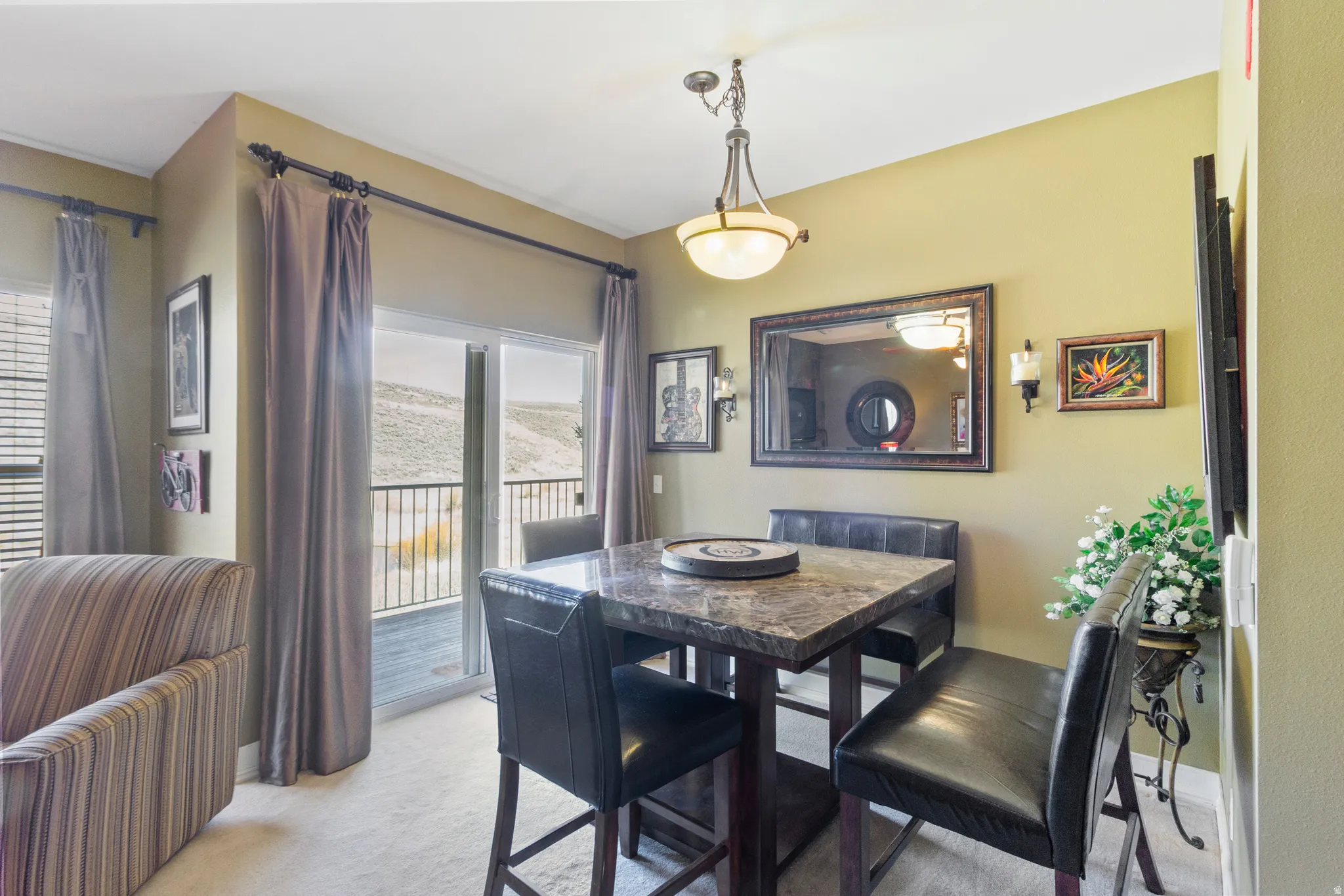 Dining space featuring light carpet and baseboards