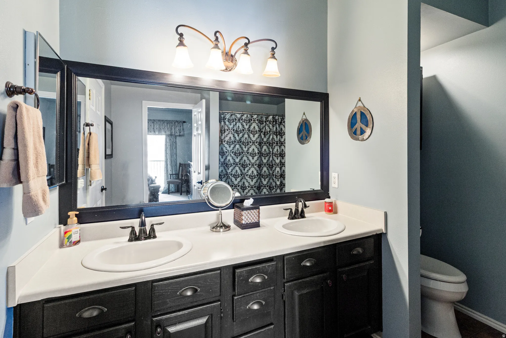 Full bath featuring double vanity and a shower with curtain