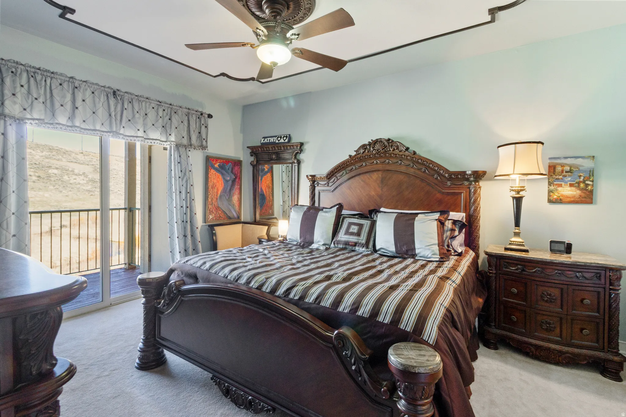 Bedroom with access to exterior, light carpet, and ceiling fan