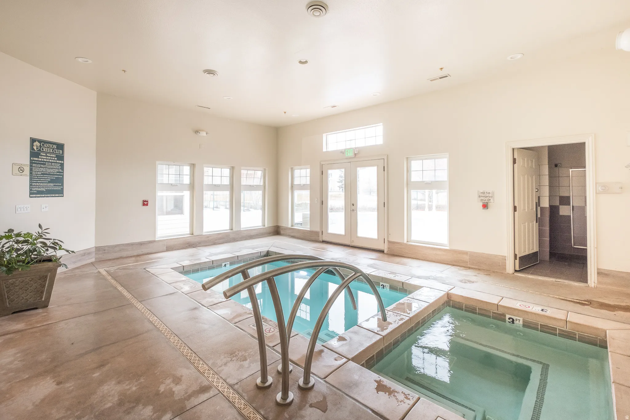 View of swimming pool with an in-ground hot tub, a pool, and french doors
