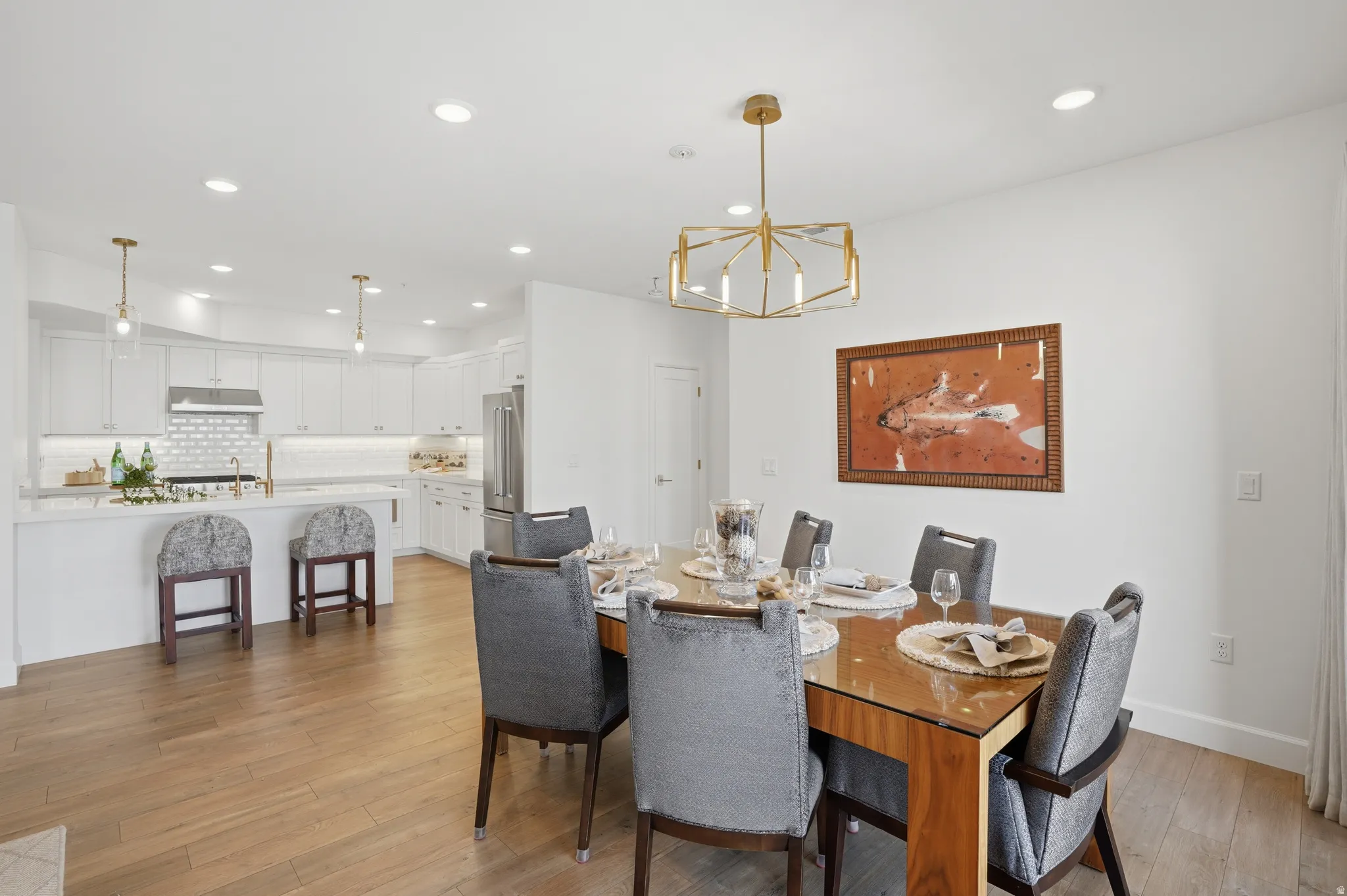 Dining room featuring suspended lighting and light wood-style floors