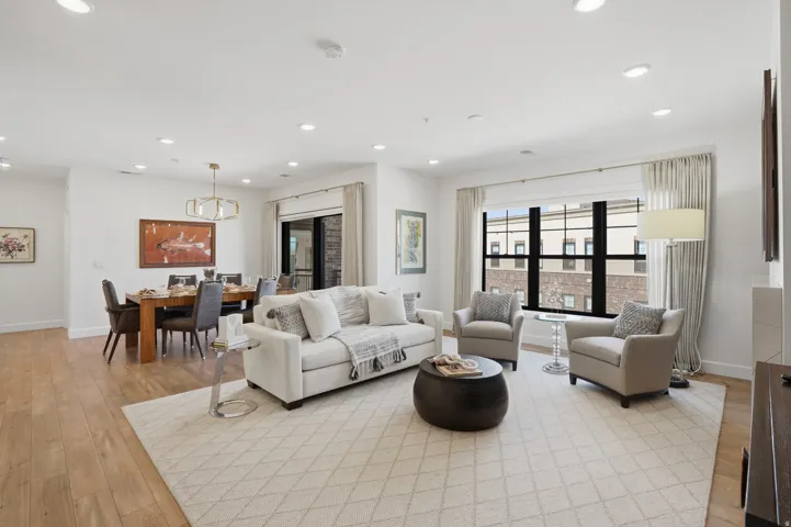 Living area with light wood-style floors and recessed lighting