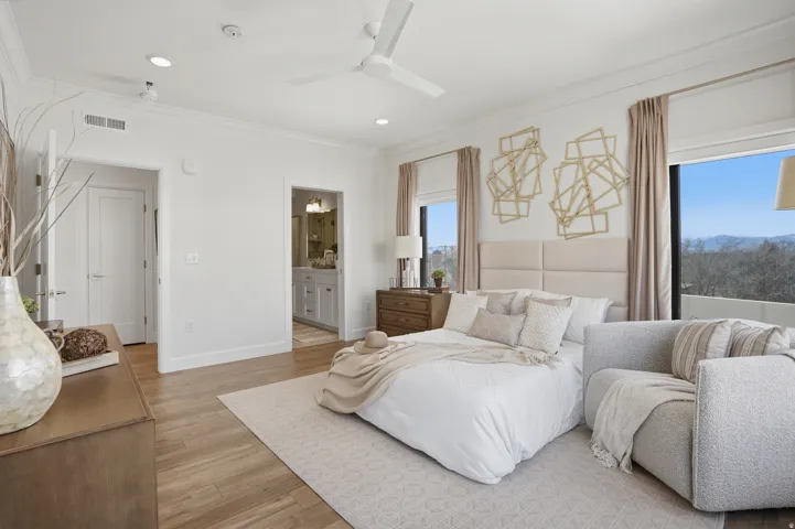 Primary Bedroom with ensuite bathroom, walk in closet, and private door to balcony