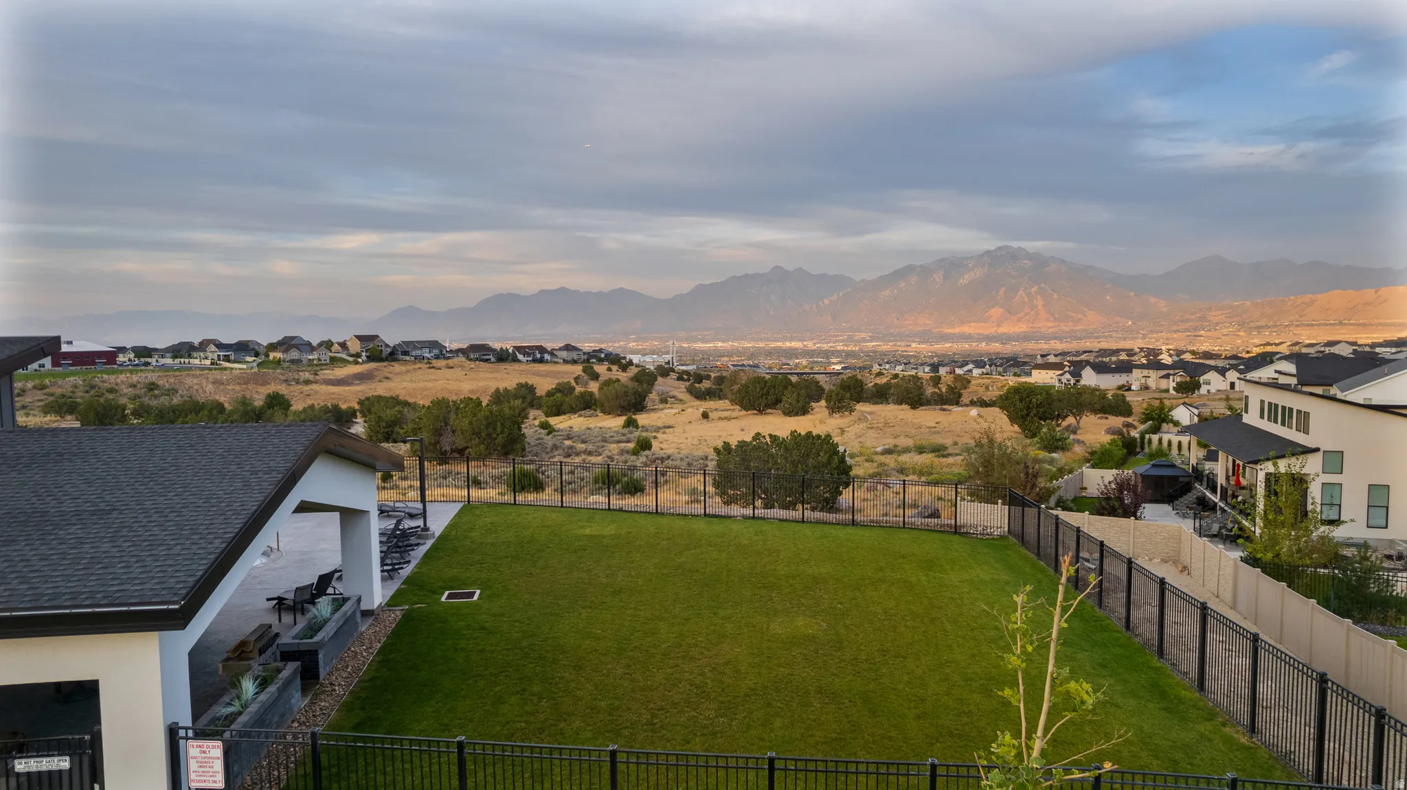 View of mountain backdrop featuring nearby suburban area