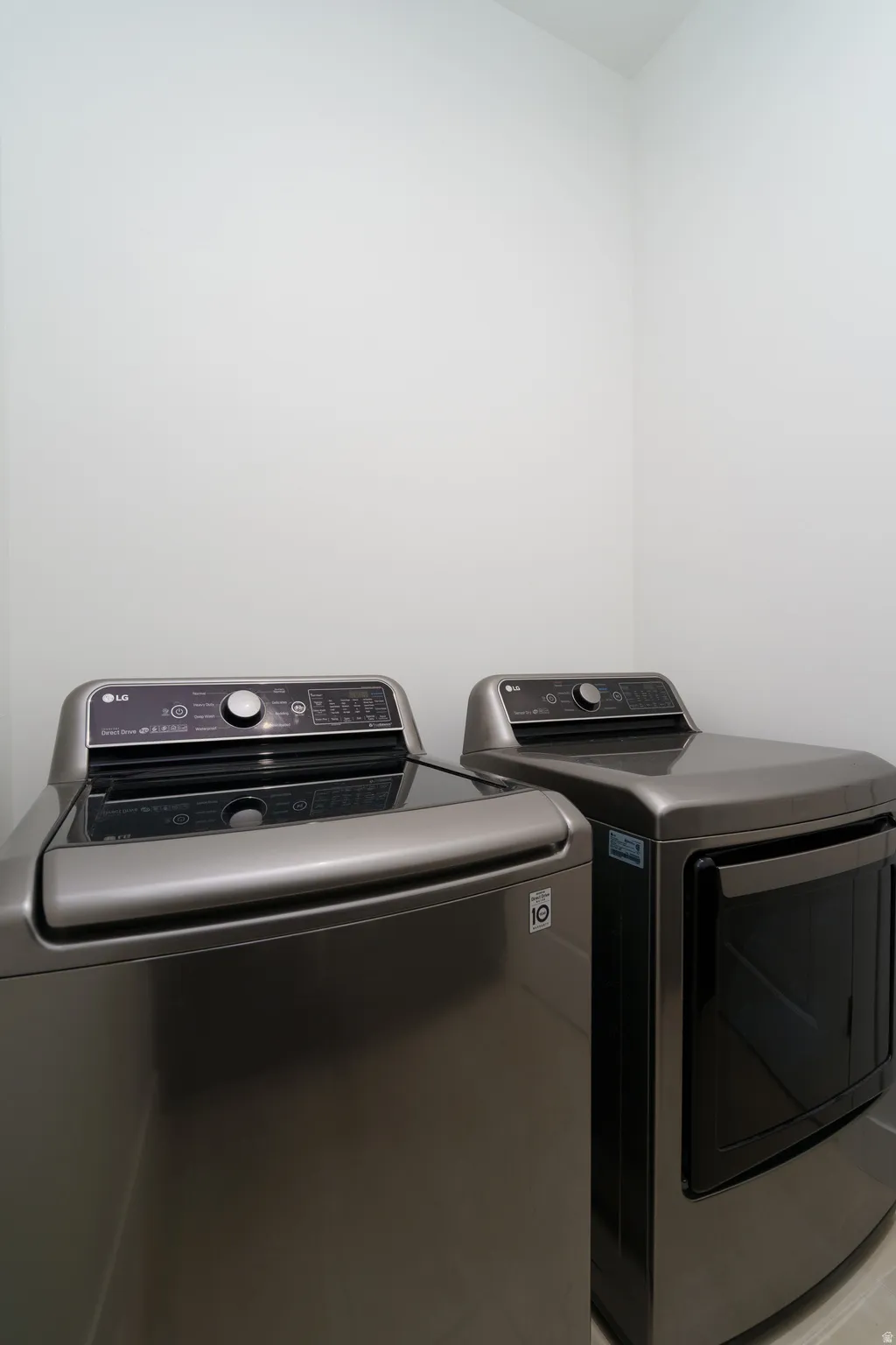 Laundry room with washer and clothes dryer