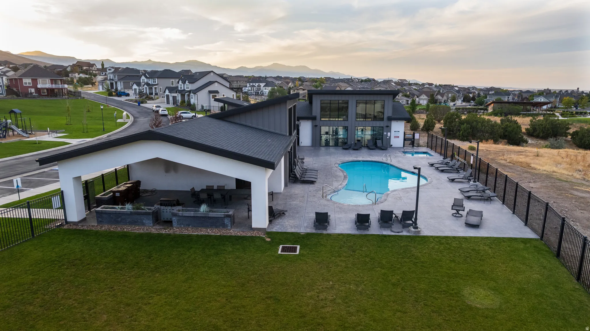 Back of house with a patio, a community pool, and a residential view