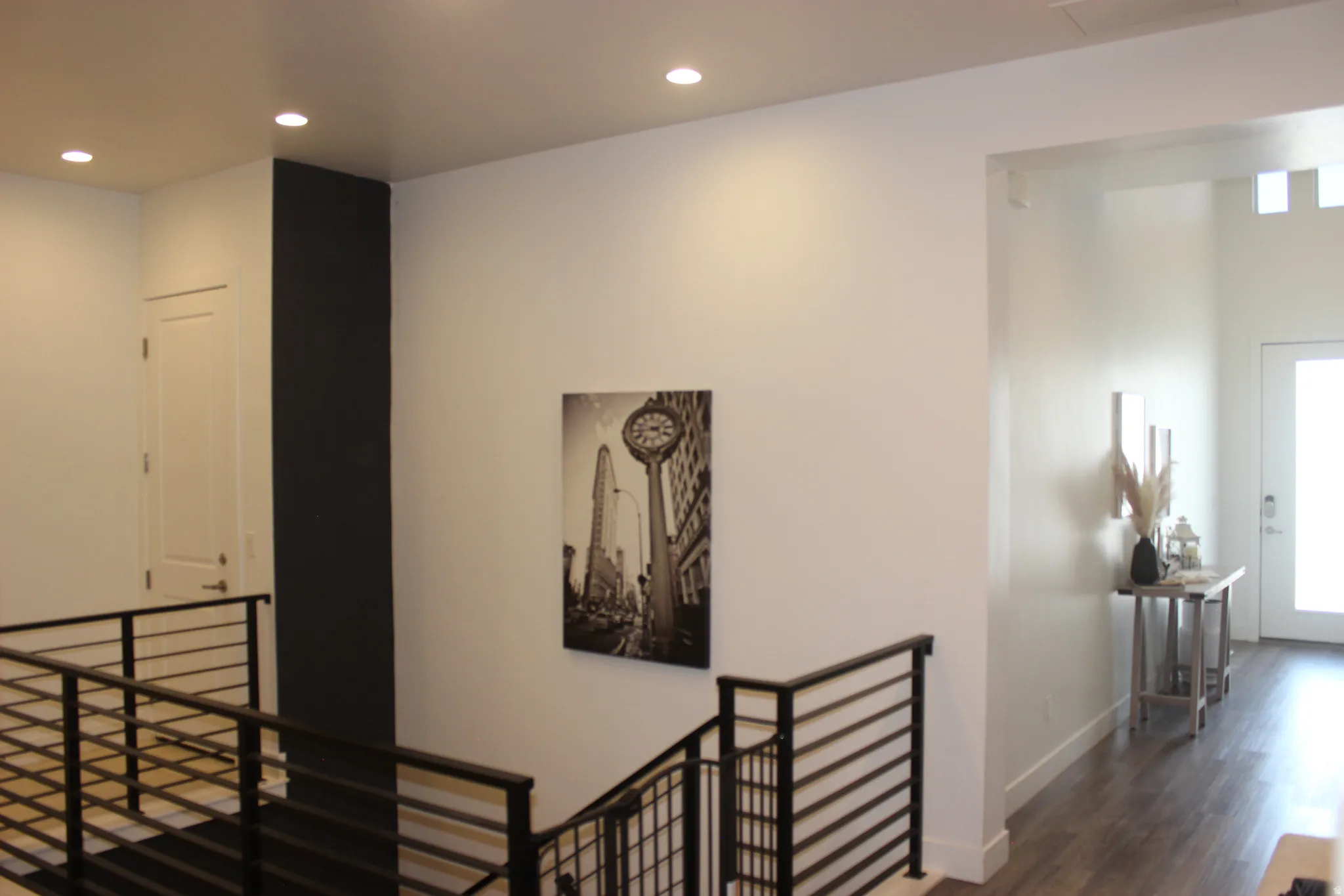 Hall with an upstairs landing, recessed lighting, and dark wood finished floors