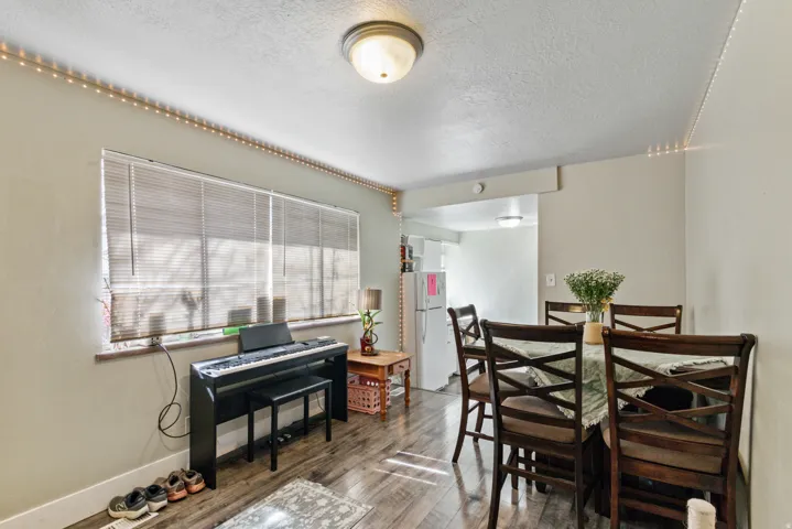 Dining room with wood finished floors and a textured ceiling