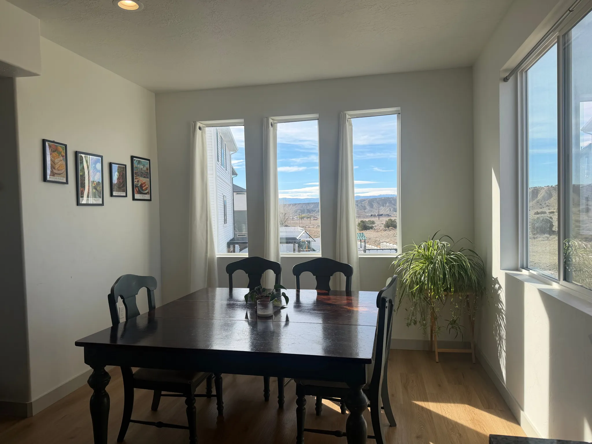 Dining space with wood finished floors and a mountain view