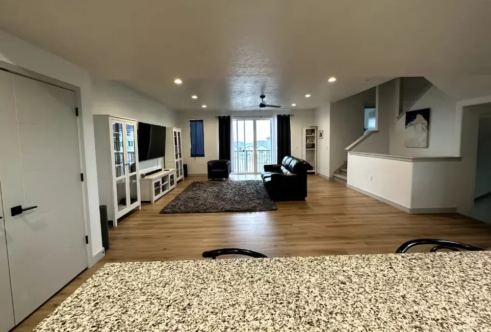 Living room with light wood-type flooring, recessed lighting, and ceiling fan