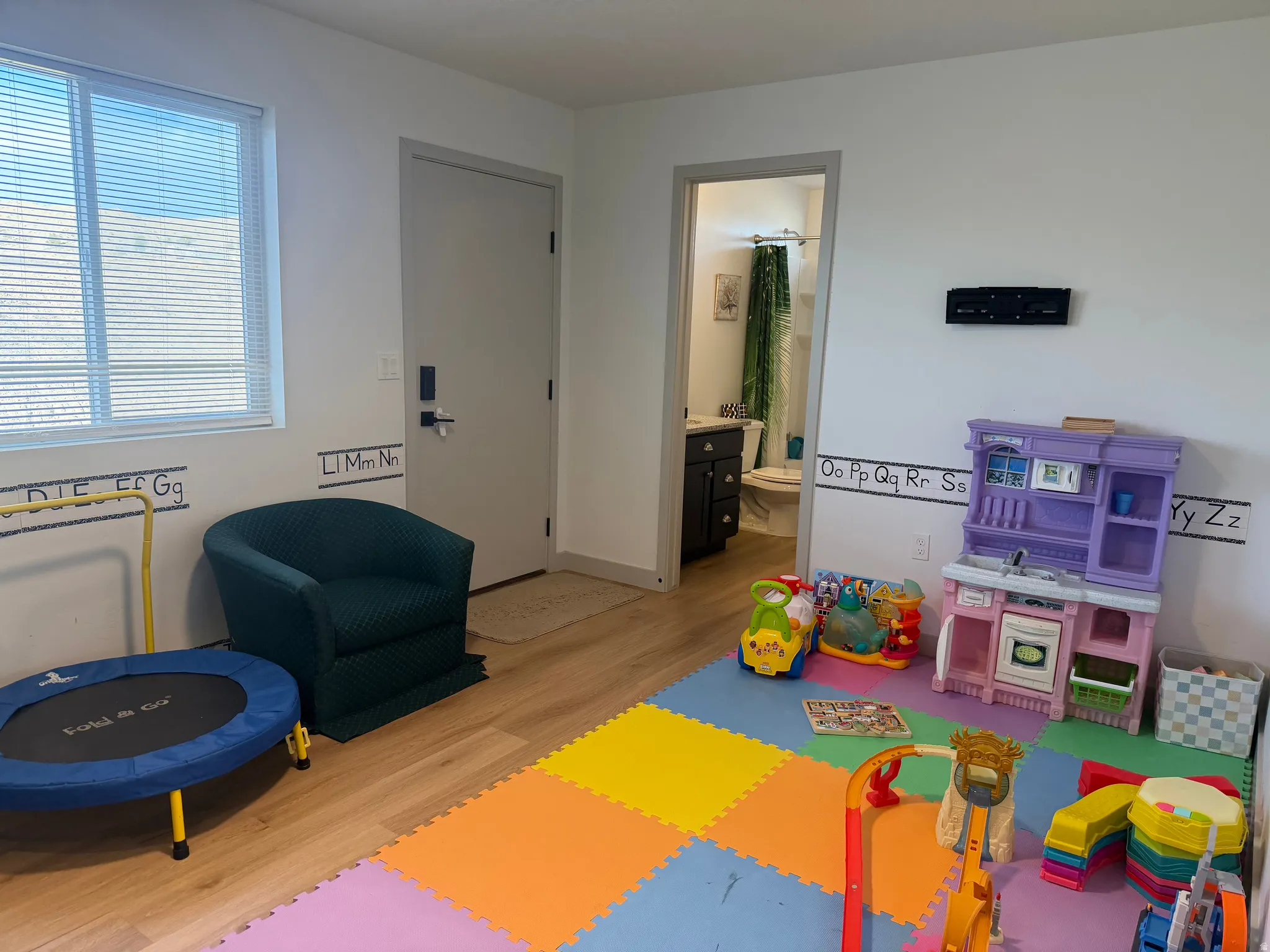 Game room with light wood finished floors