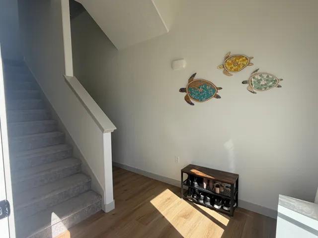 Stairway with baseboards and wood finished floors
