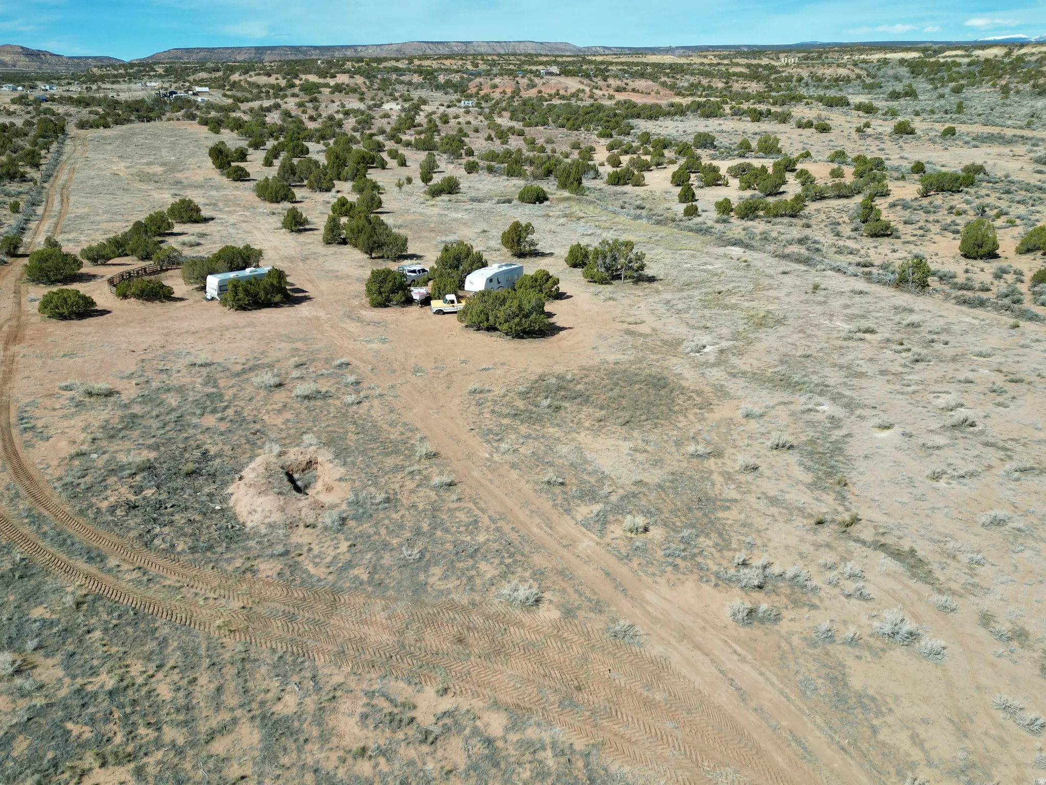 Aerial view of sparsely populated area featuring a desert landscape and a mountain backdrop