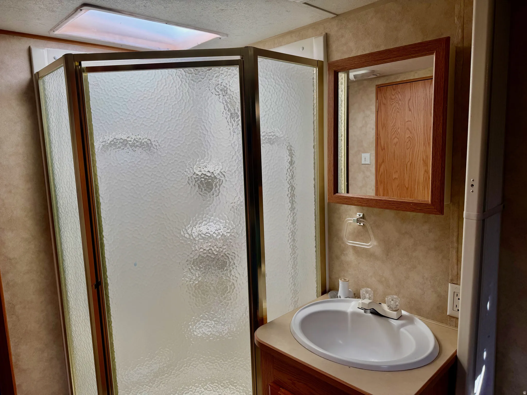 Full bathroom featuring vanity and a stall shower