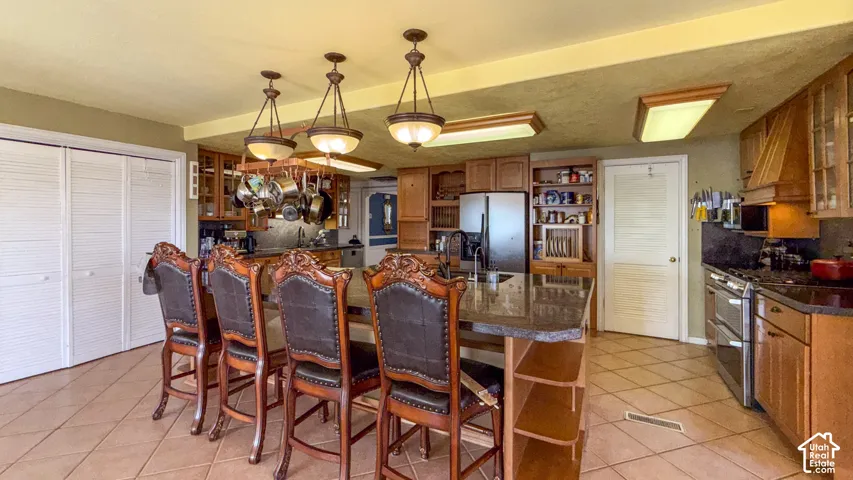 Kitchen featuring open shelves, wood finish cabinets, and glass insert cabinets
