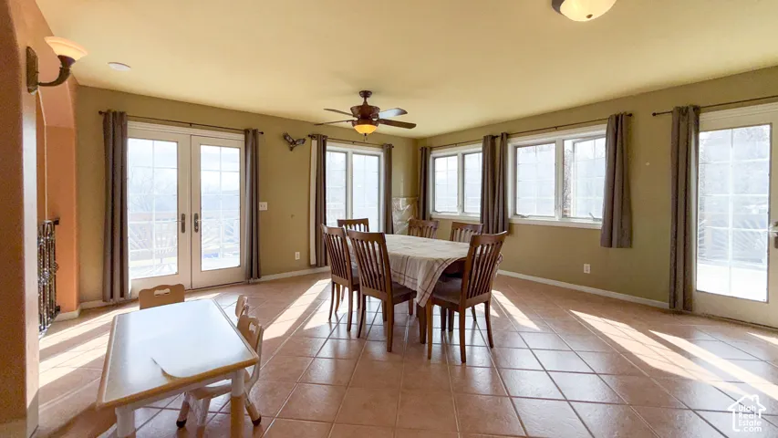 Dining area featuring french doors, light tile patterned floors, and plenty of natural light
