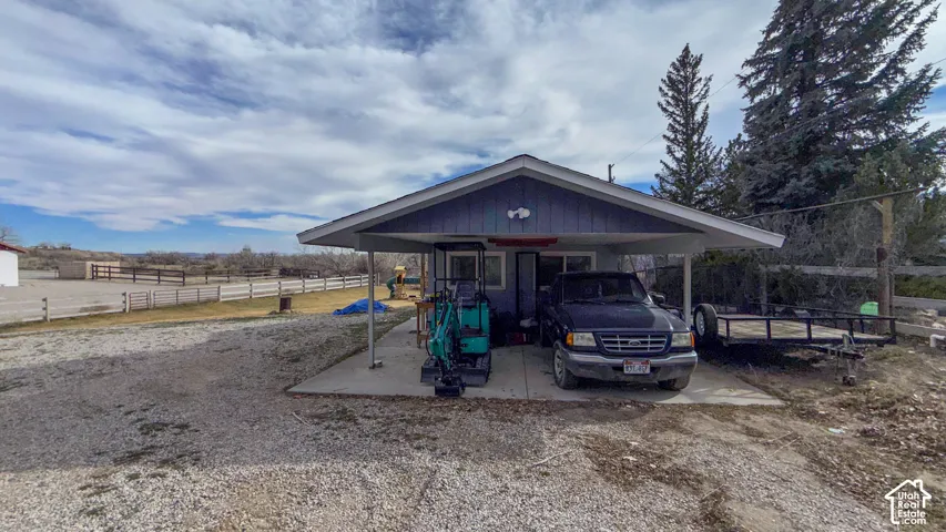 View of front of home with an attached carport and a porch
