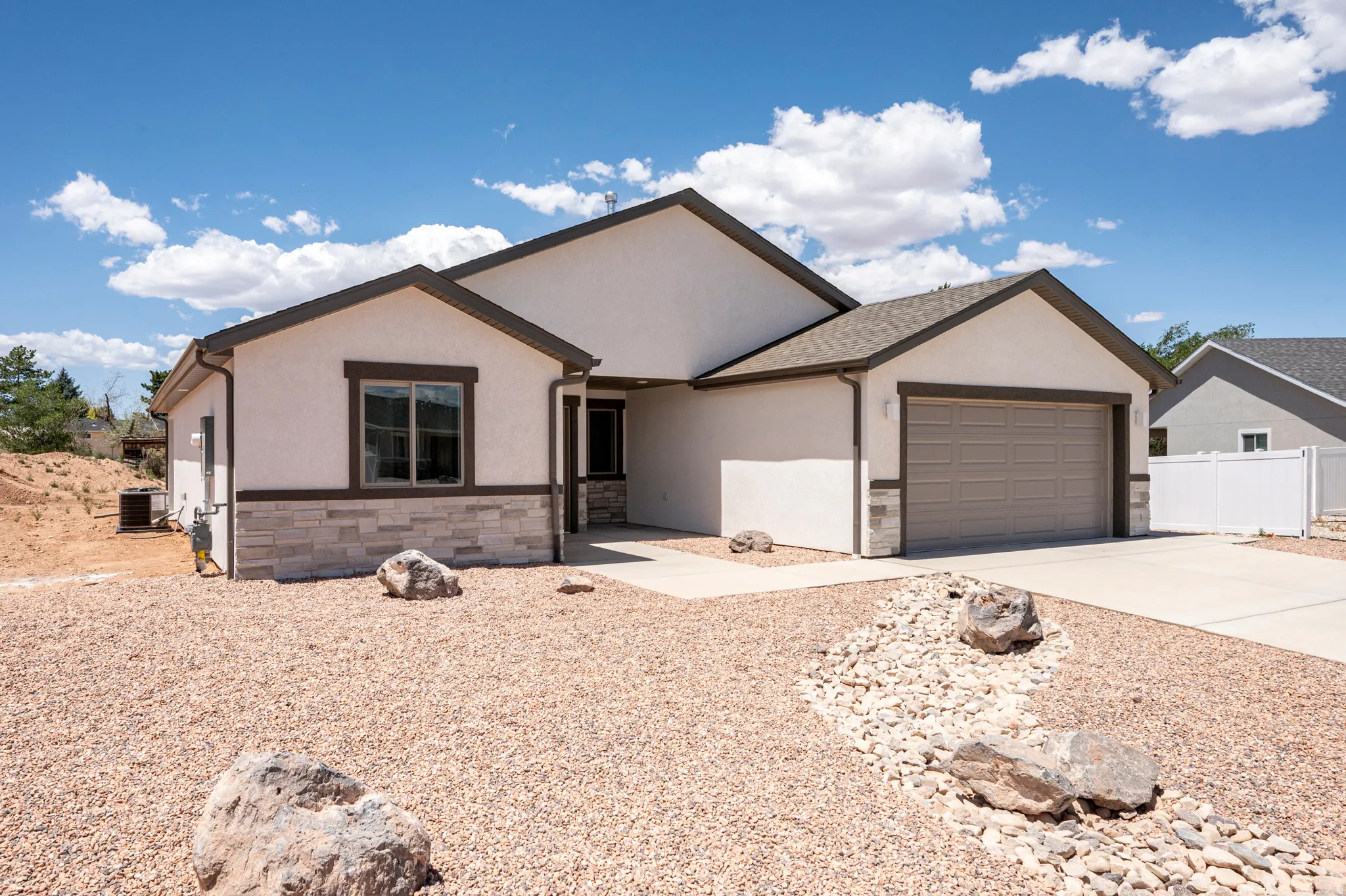Contemporary stucco exterior with stone accents and a neutral color palette